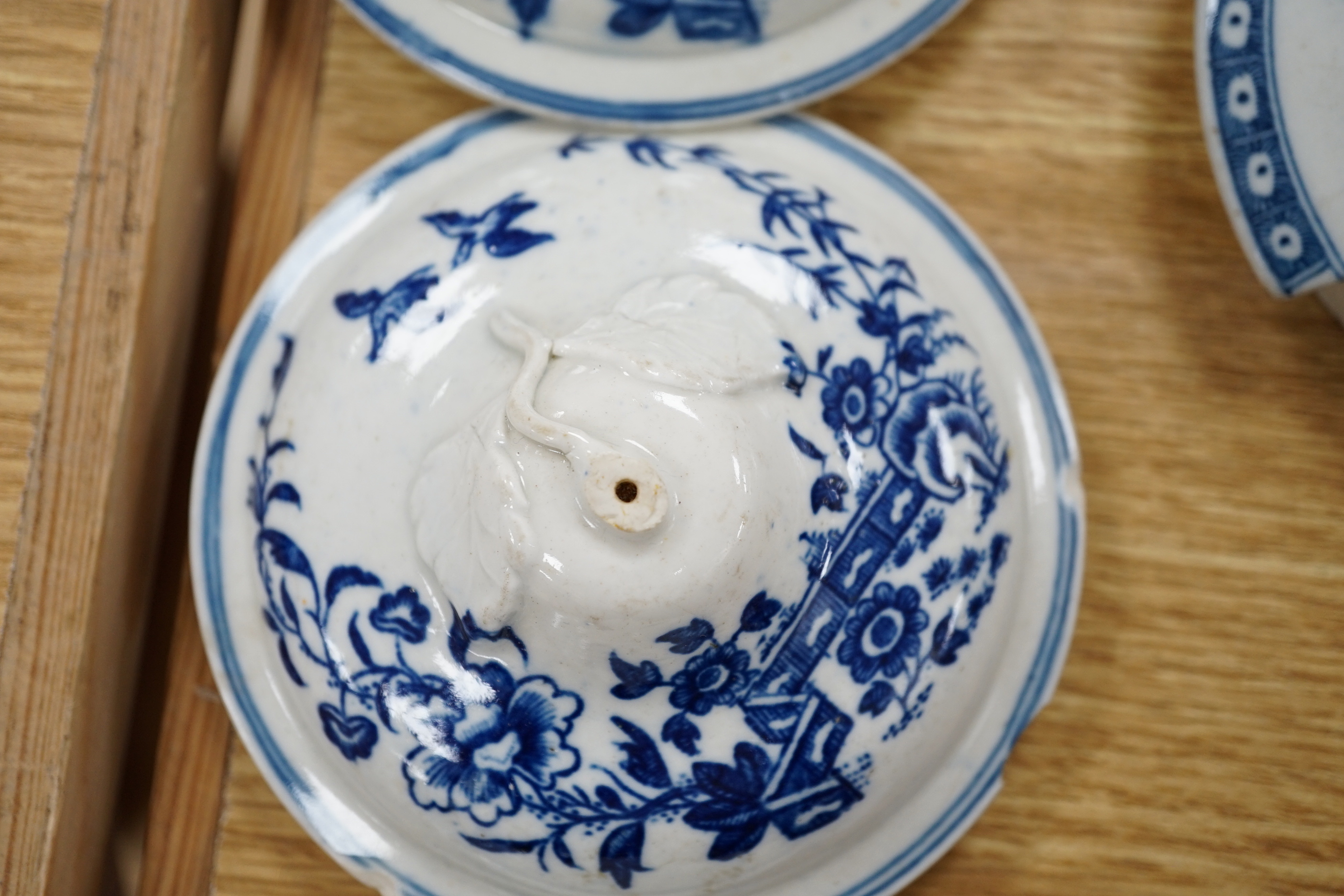 A 19th century Abbotsford pattern blue and white tureen and cover, various dishes and a collection of early Worcester tea and coffee pot covers